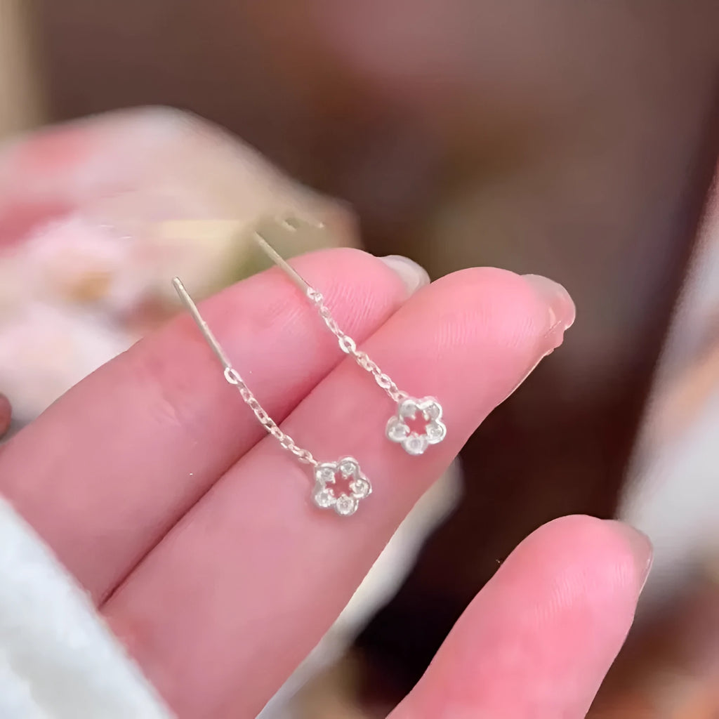 Silver hollow flower hanging earrings with petal design and sterling silver needle