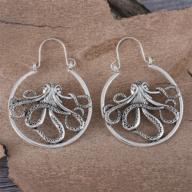 A pair of vintage-style octopus-shaped earrings in an antique silver colour.