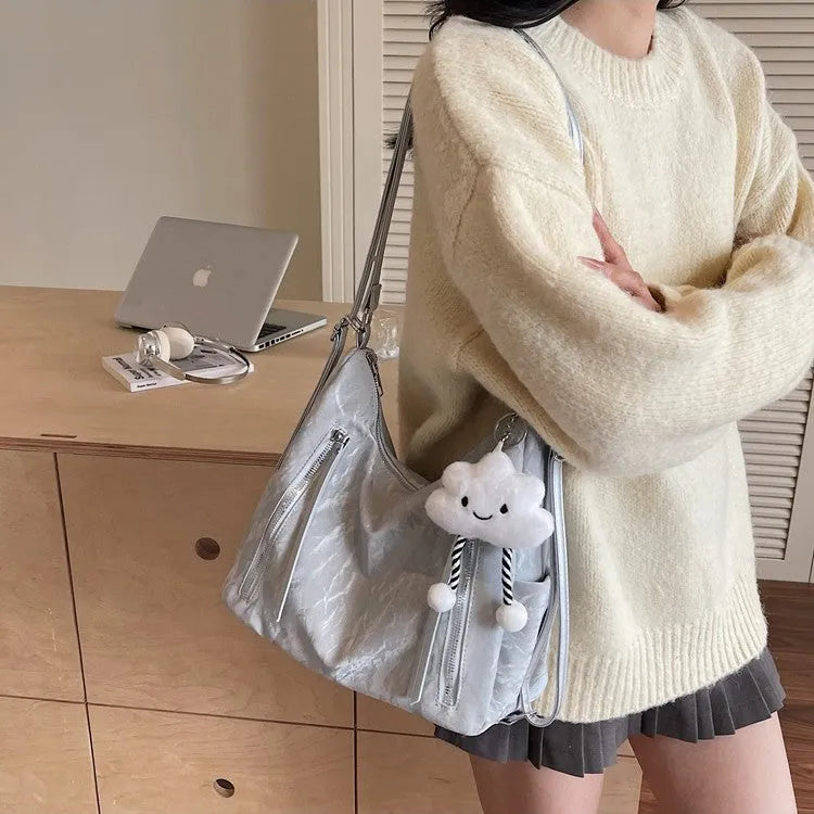 Women's PU leather fashion backpack in beige, black, blue, or silver with pendant accessory