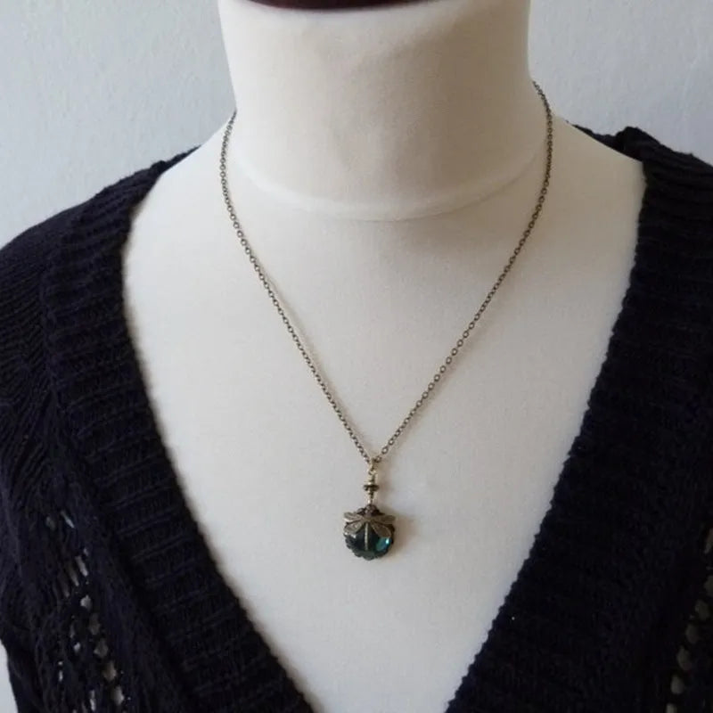 Hand-carved dragonfly pendant necklace in yellow bronze finish on a 925 silver chain.