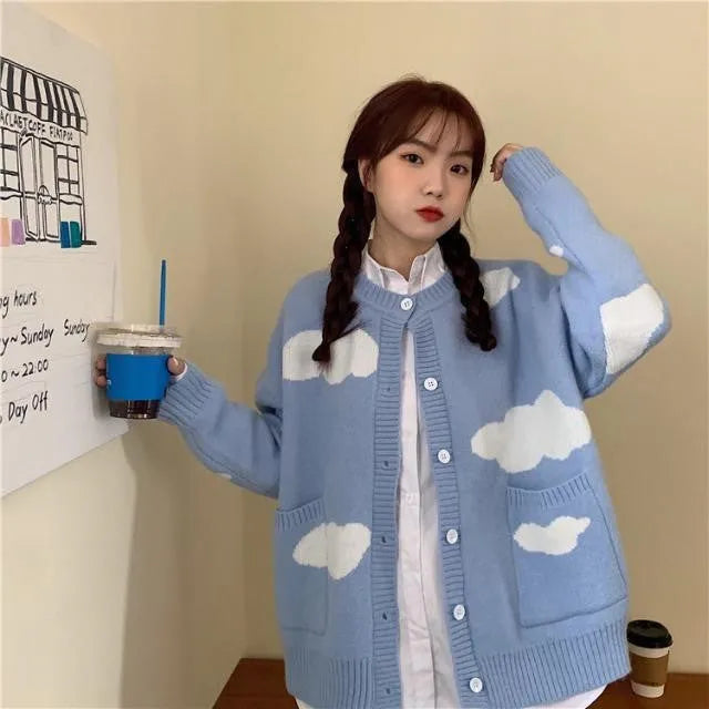 Blue women's loose spandex cardigan with white cloud pattern, worn open.