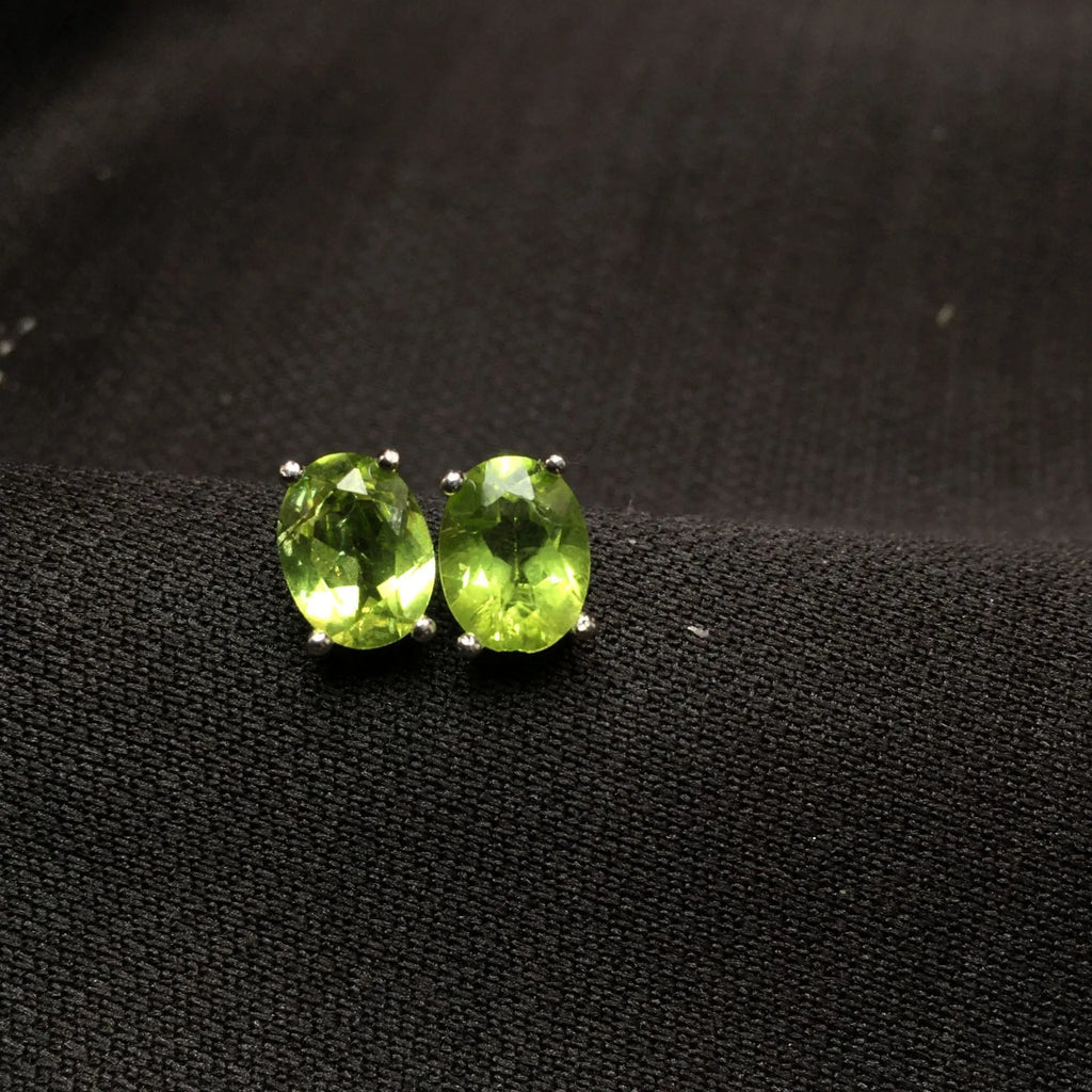 Grass green natural olivine stud earrings in sterling silver, elliptical stones 6x8mm.
