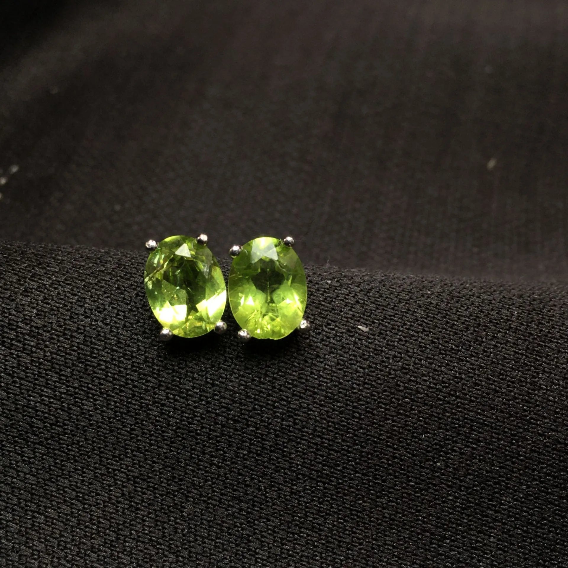 Grass green natural olivine stud earrings in sterling silver, elliptical stones 6x8mm.