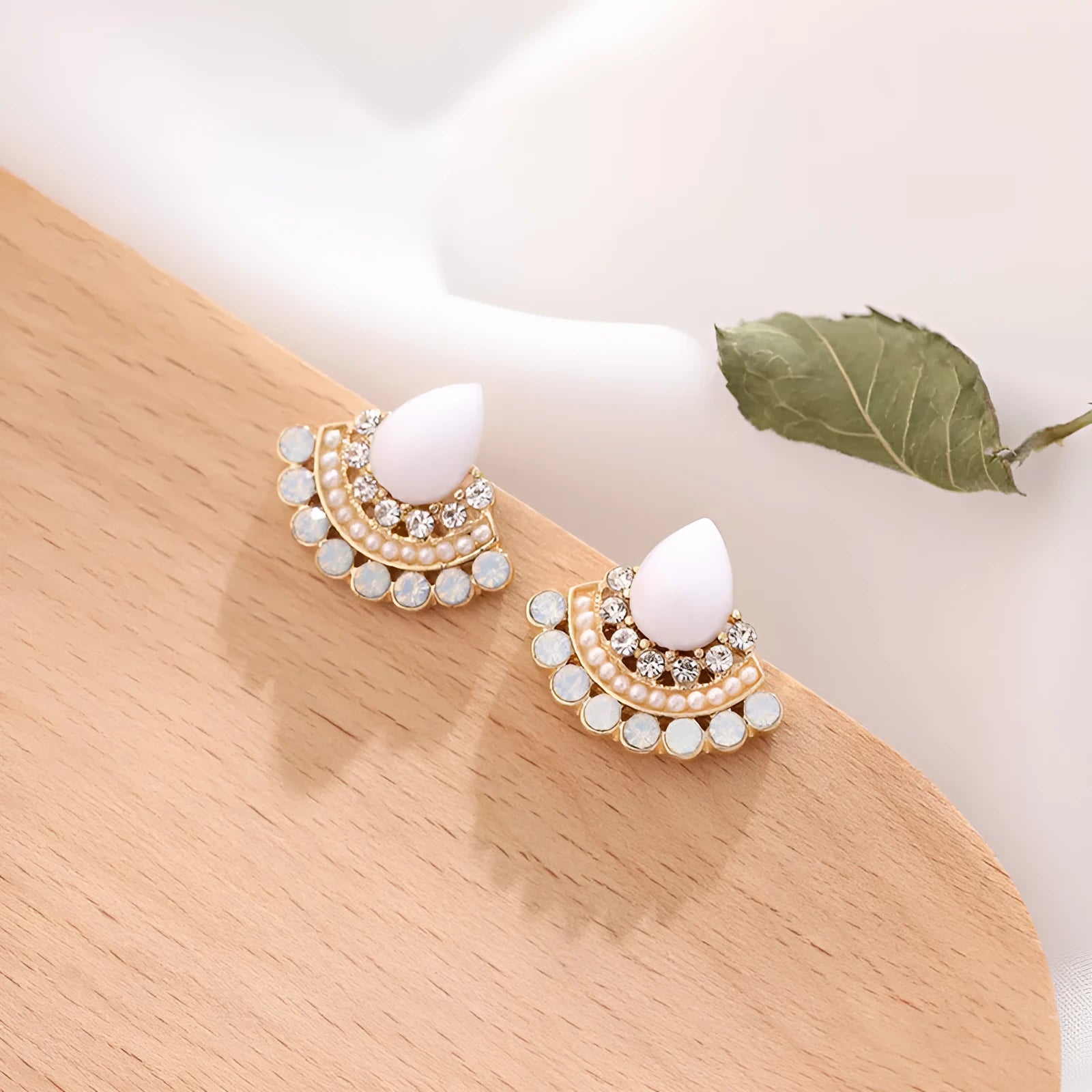 Women's retro fan-shaped silver needle earrings with rhinestone detailing on a geometric design.
