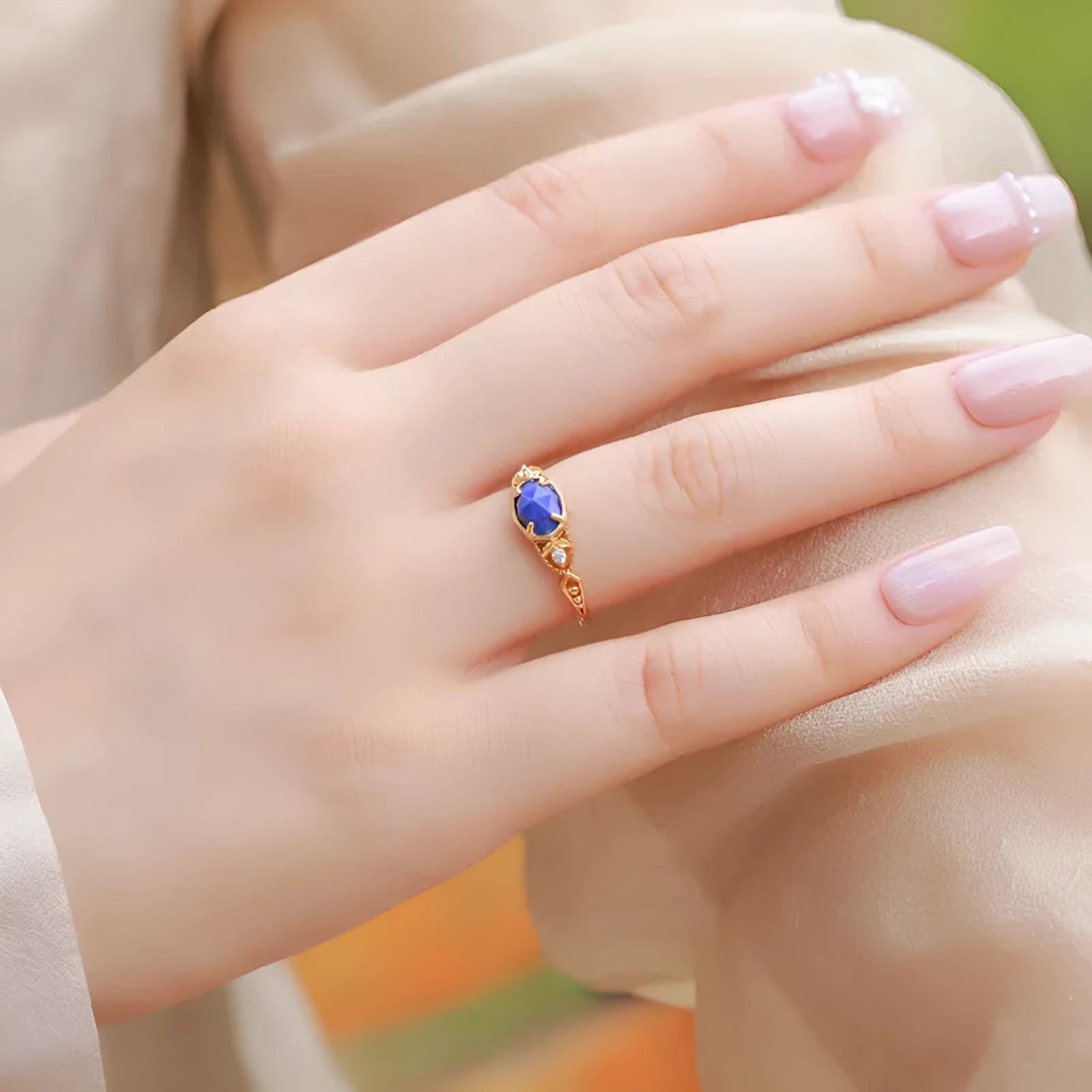 Geometric silver women's ring with a blue oval lapis lazuli gemstone.