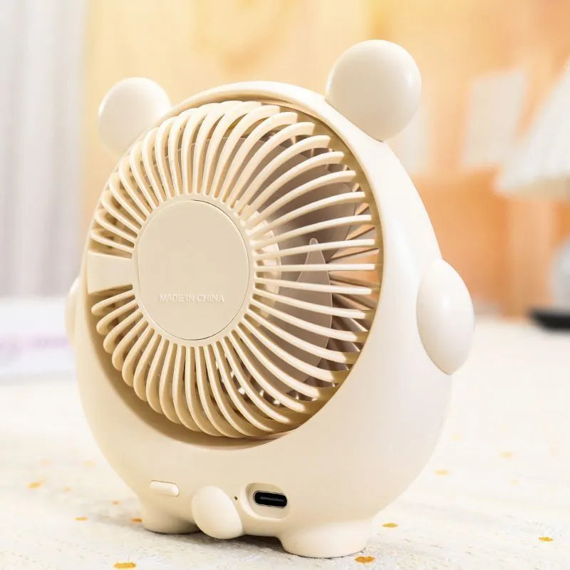 Cute dog-themed USB desktop electric fan in a choice of six colours on a wooden desk.