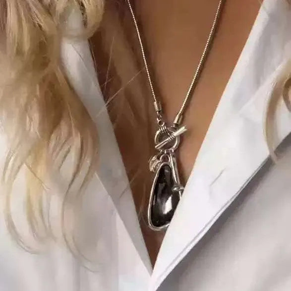 Long women's necklace with geometric pendant on snake bones chain
