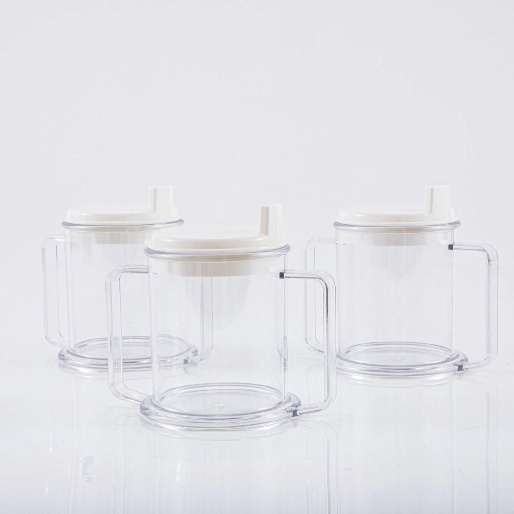 Transparent spill-proof drinking cup with lid on white background