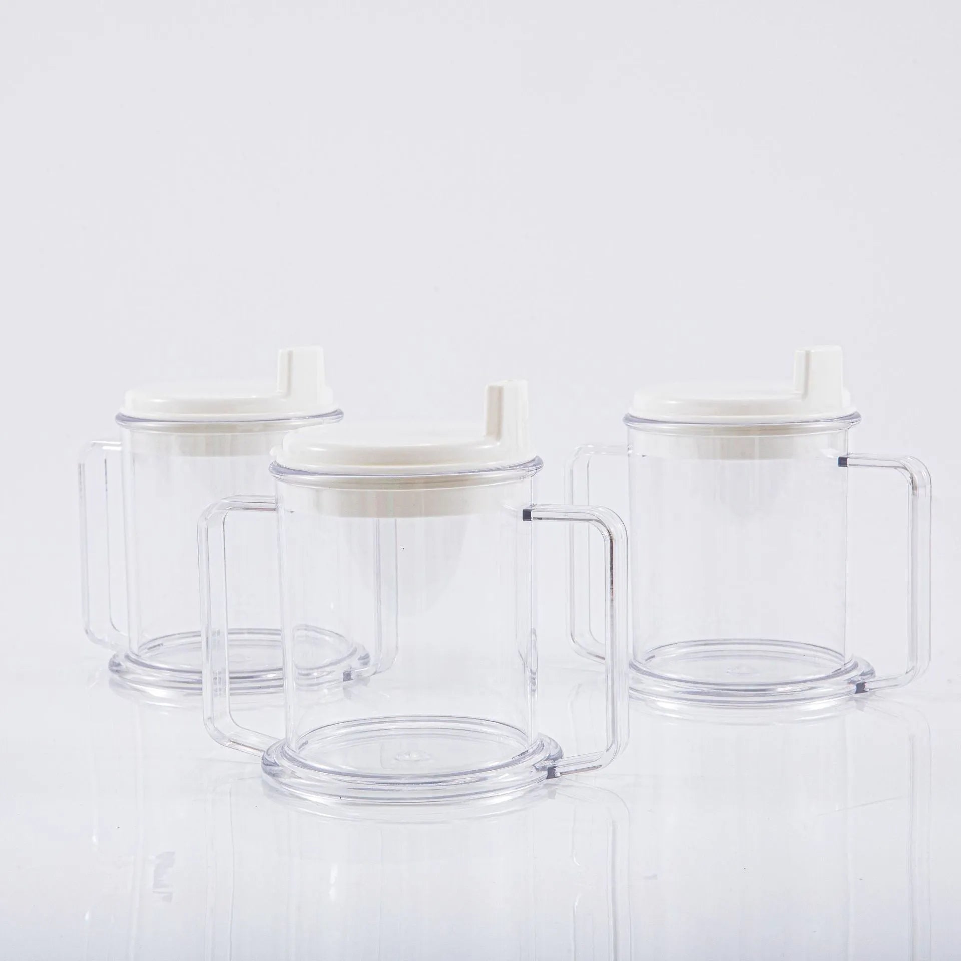 Transparent spill-proof drinking cup with lid on white background