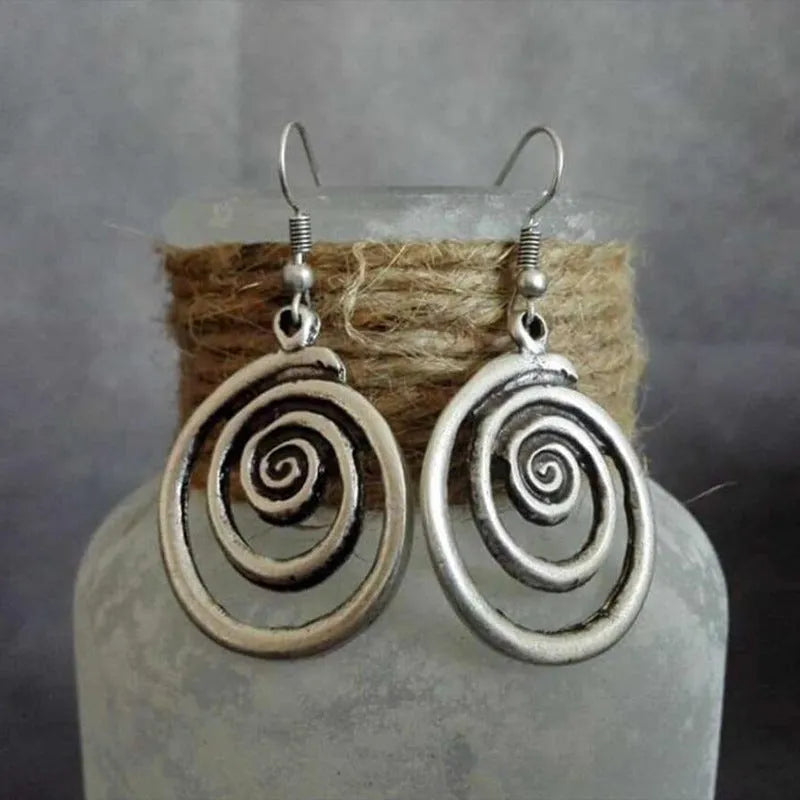 Retro geometric spiral distressed silver earrings showing 2.6cm width and 5cm length dimensions