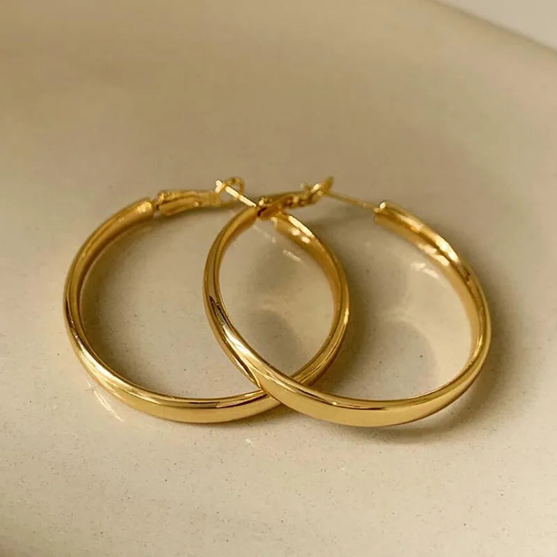 Metal circle earrings with gold or silver electroplated finish measuring 40mm diameter