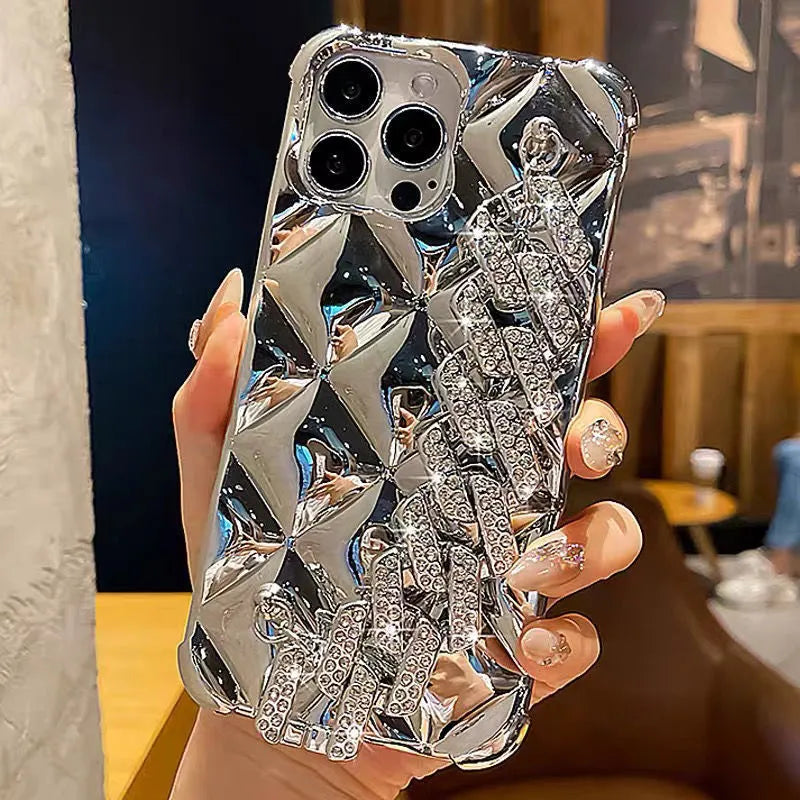 Gold diamond bracelet chain phone case for iPhone on a table.