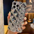 Gold diamond bracelet chain phone case for iPhone on a table.