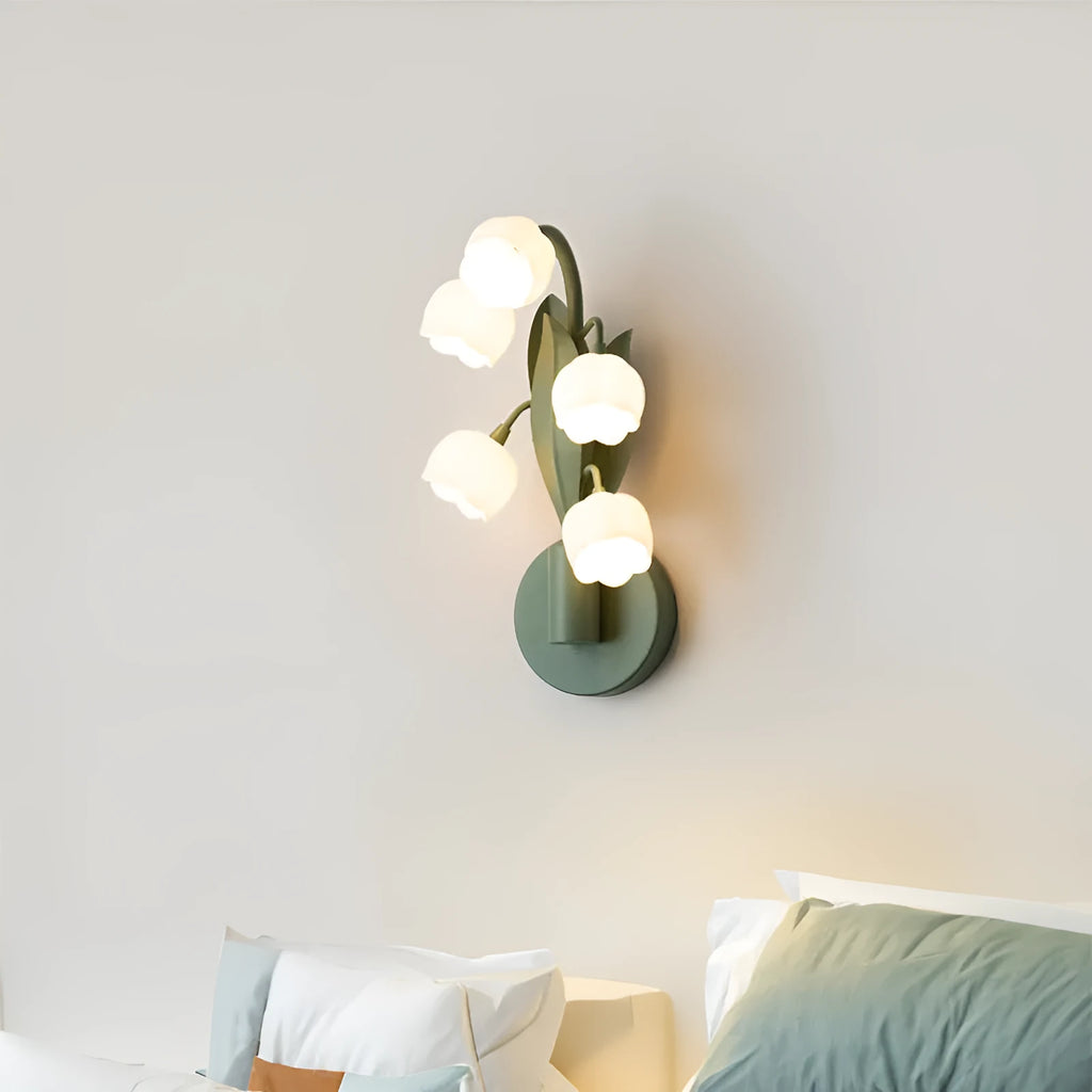 Modern minimalist French pastoral wall lamp with a green tricolour light and white PC shade mounted on a bedroom wall.
