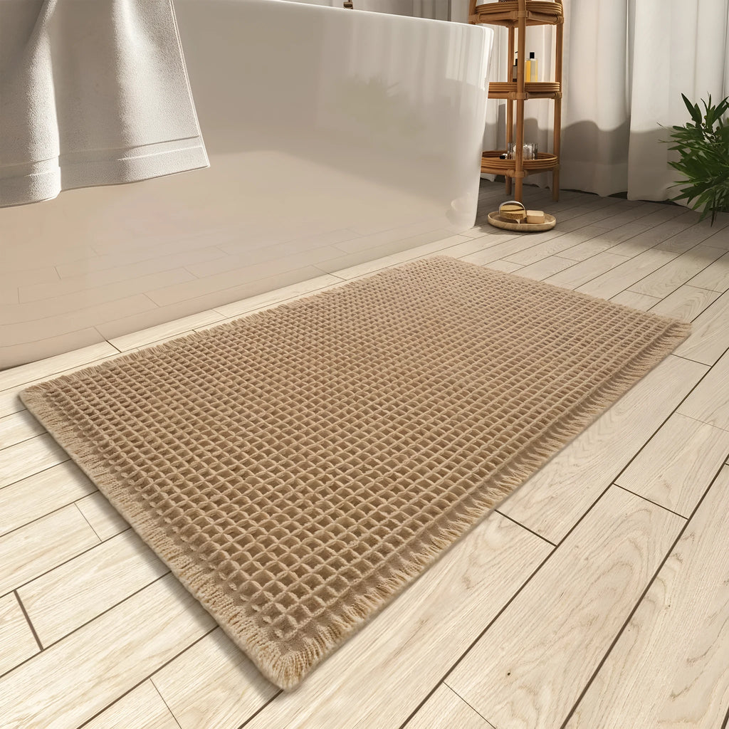 Checkered patterned non-slip absorbent bathroom floor mat in a neutral colour on tiles.