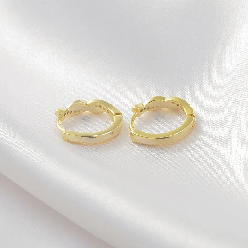 Geometric hemp rope earclip earrings in gold colour with interwoven copper construction