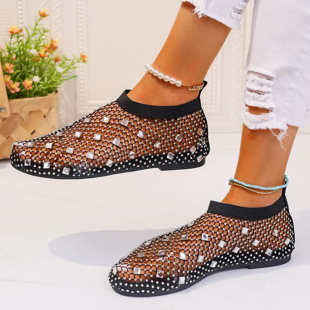 Colourful rhinestone detail on the mesh upper of women's white flat sandals with a round toe.