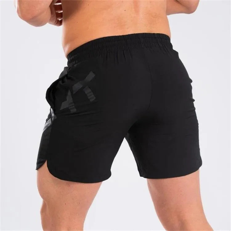 Men's black knee-length training shorts with an elastic waistband, made from quick-dry nylon blend fabric.