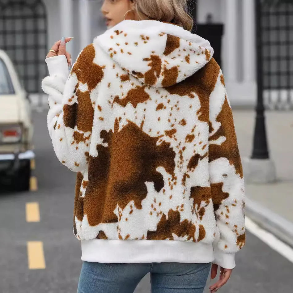 Yellow brown cow animal print hooded cardigan jacket with full zipper on a model.