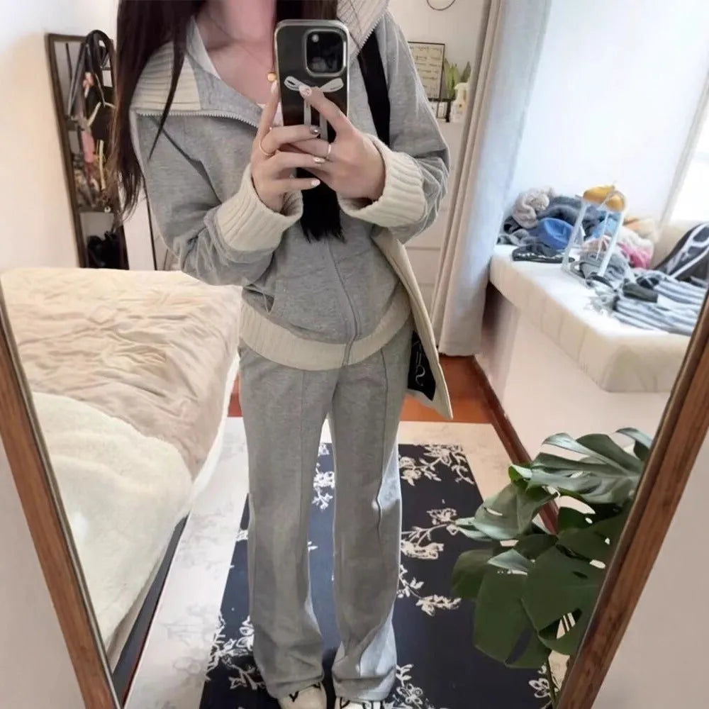 Women's light gray polyester two-piece set consisting of a pocket coat and wide leg trousers, shown flat lay view.