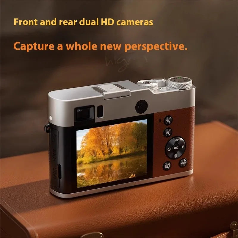 Black or brown 5K digital camera with front and rear lenses and an optical viewfinder on top.