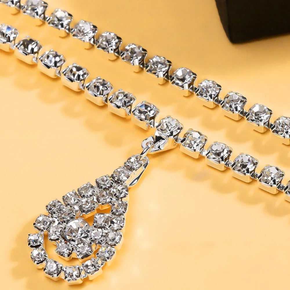 Gold or silver women's waist chain with water drop pendant and rhinestone decoration, showing lobster clasp closure.