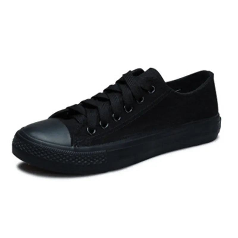Women's casual canvas shoes in solid colours on a flat sole, showing lace-up fastening.