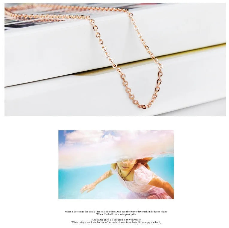 Rose gold women's necklace with a pink artificial crystal heart-shaped pendant on a cross chain