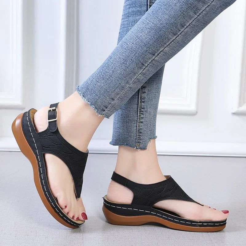 Women's wedge heel sandals with an adjustable buckle strap in a solid colour