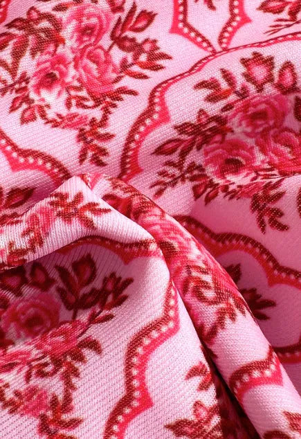 Printed pink split bikini set with exposed back and adjustable shoulder straps on woman
