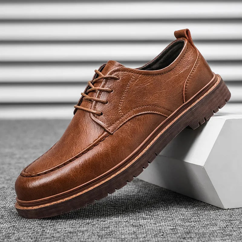 Men's black casual leather shoes with a round toe and flat rubber sole on a white background