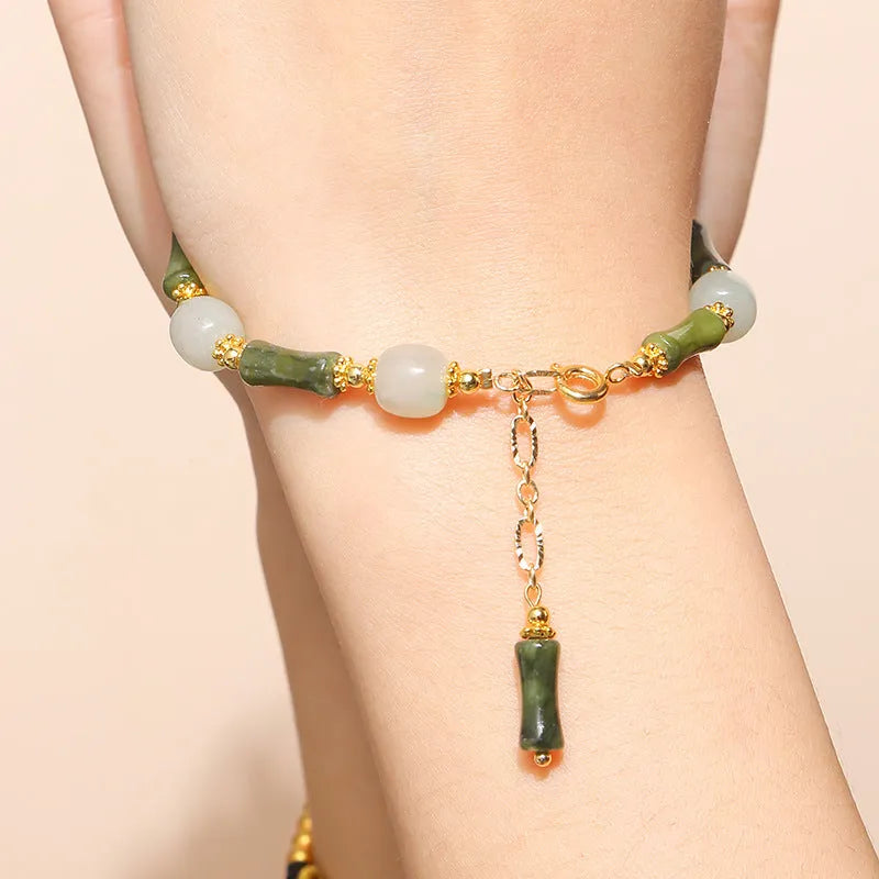 Crystal agate bracelet with natural gemstone beads and zodiac charm on a wrist.