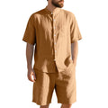 Man wearing a light blue short sleeve linen shirt jacket and matching shorts, a two-piece summer suit.