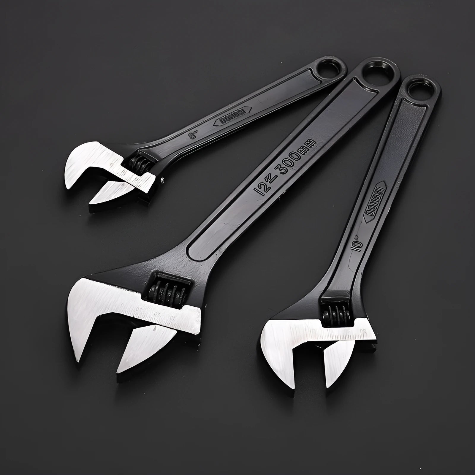 10-inch black high carbon steel adjustable open-end wrench on a workbench.