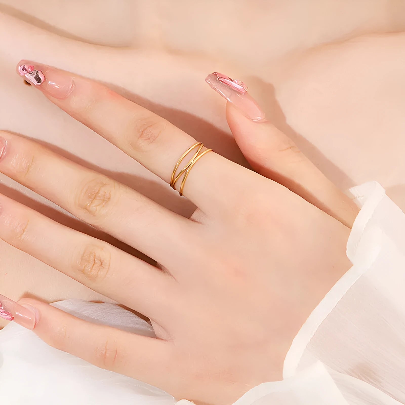 Geometric gold-coloured titanium steel ring with three-layer coil design shown at various angles
