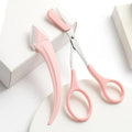 White and pink eyebrow trimming knife with curved blades and comb for brow and lash grooming.