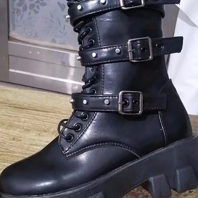 Women's black mid-calf buckle boots with side zipper and round toe, showing metal buckle detail