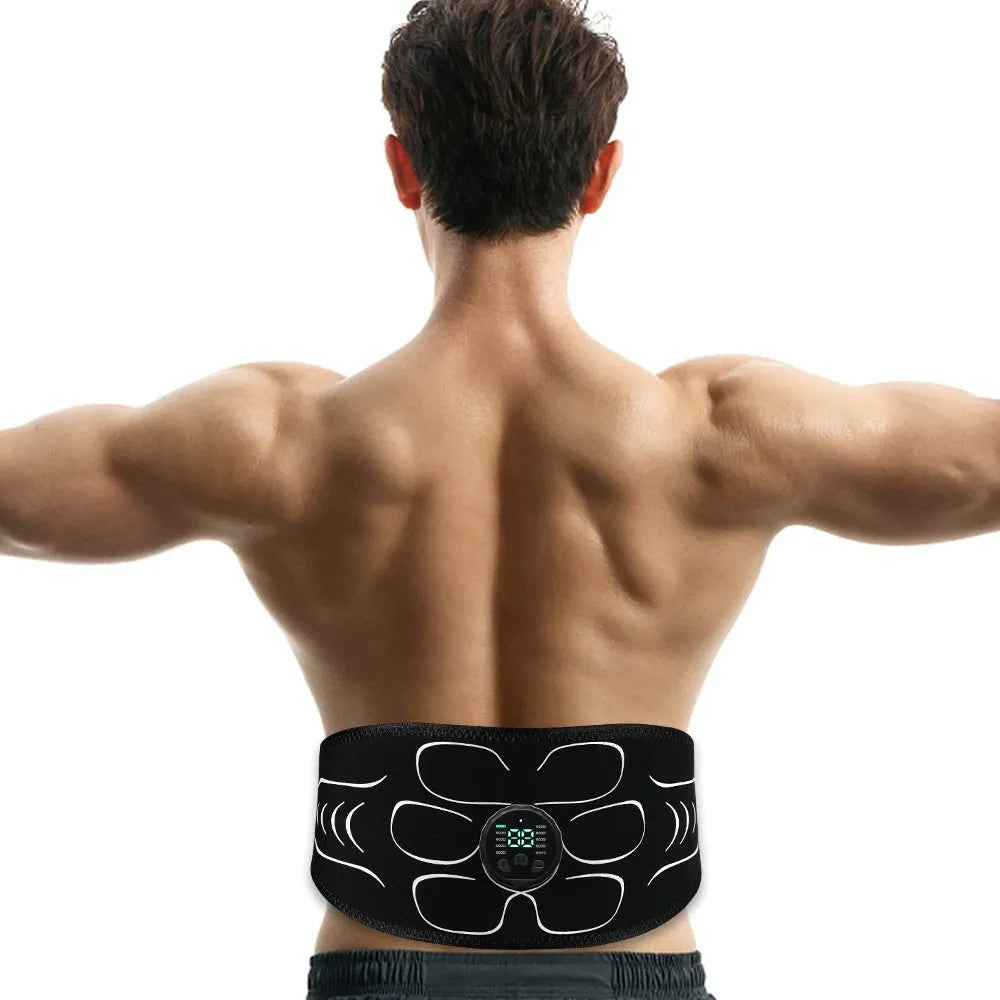 Silicone EMS belly shaping belt with muscle stimulator and hand and foot straps on a flat surface