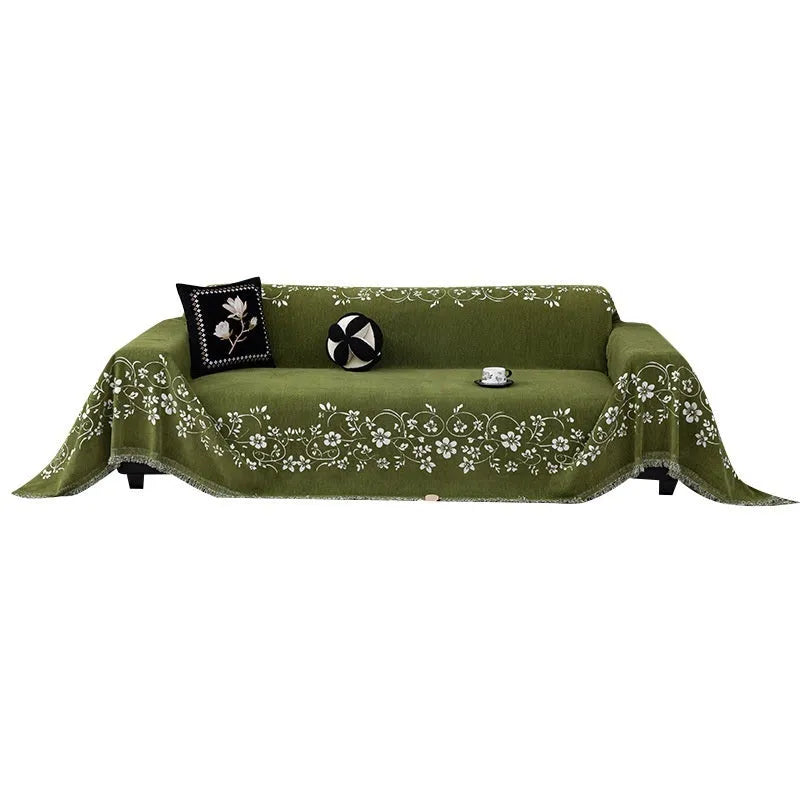 Chenille sofa cover with embroidered magnolia pattern in garland black, coffee, and green colours