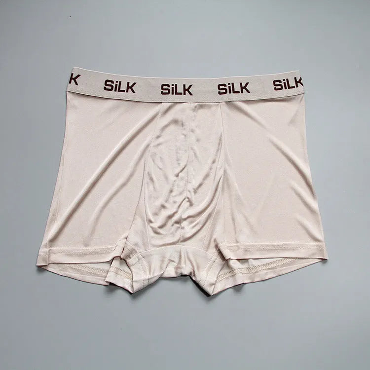Men's loose fit silk shorts in navy blue, shown with mid waist design
