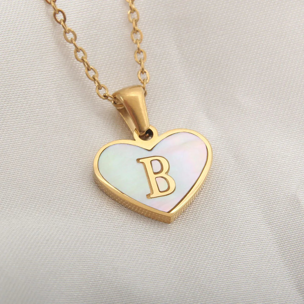 Personalised white shell heart necklace with gold chain and initial letter engraving