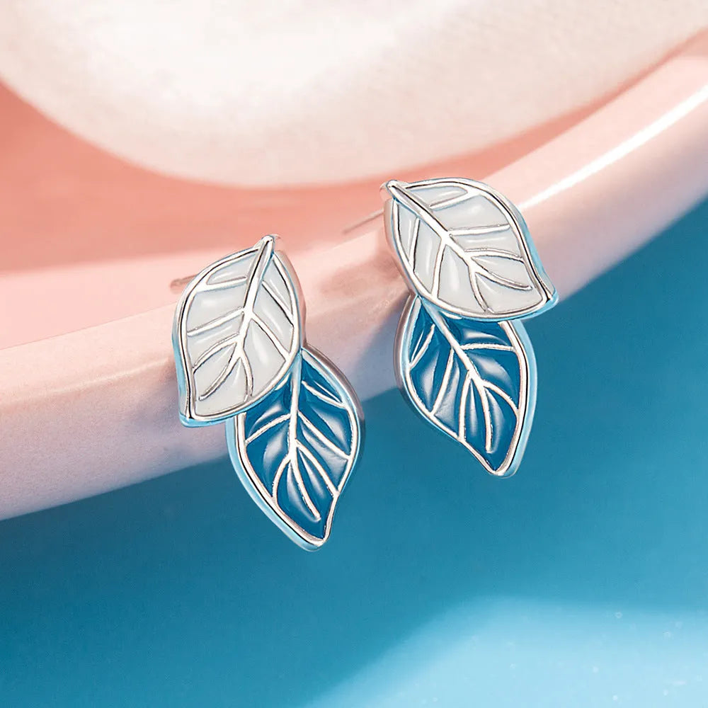 Copper leaf-shaped stud earrings with white gold colour plating and post fastening