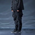 Black waterproof paratrooper trousers with integrated pant straps and 100% polyester fibre construction
