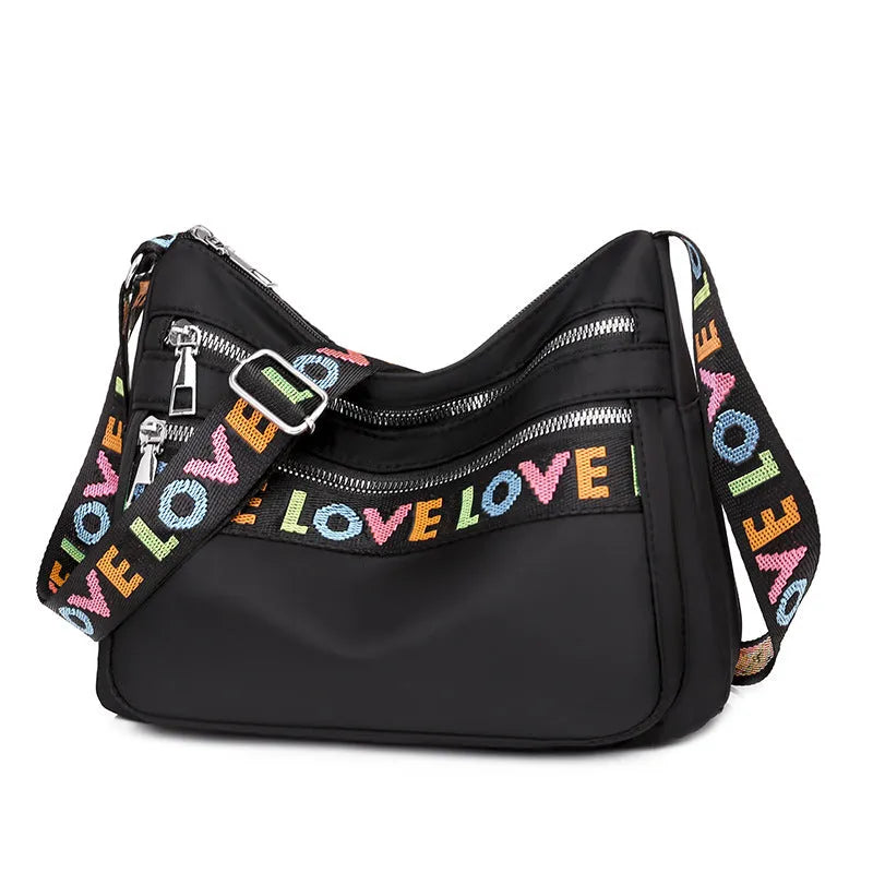 Oxford cloth crossbody shoulder bag in red or black with single strap, multi-pocket large capacity, and letter stitching details