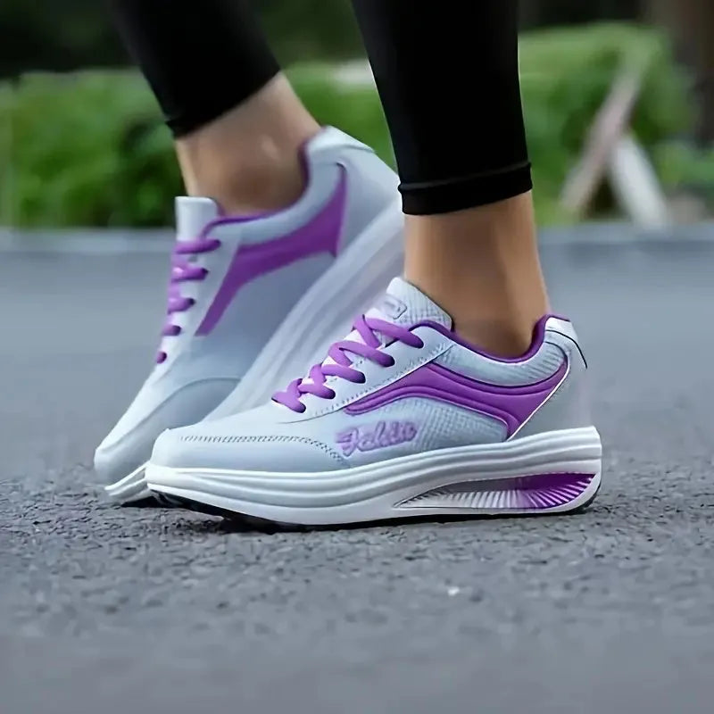 Women's grey pink mid-heel sports shoes with heelless sole design on a light background