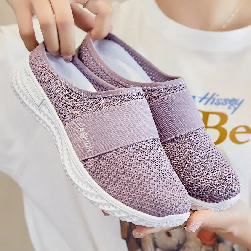 Women's casual flat shoes with mesh upper and hollow-out design in black, grey, pink or purple.