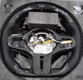 Black carbon fibre BMW sports steering wheel with LED display and multifunctional buttons.
