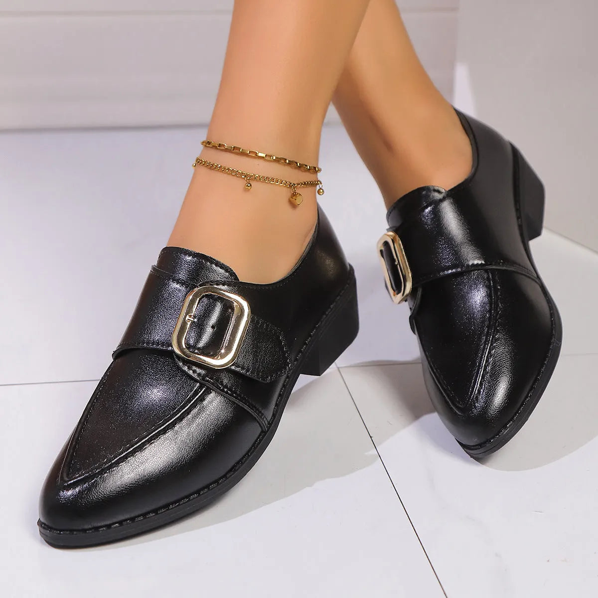 Women's British-style leather-look slip-on shoes with a decorative bow on the front
