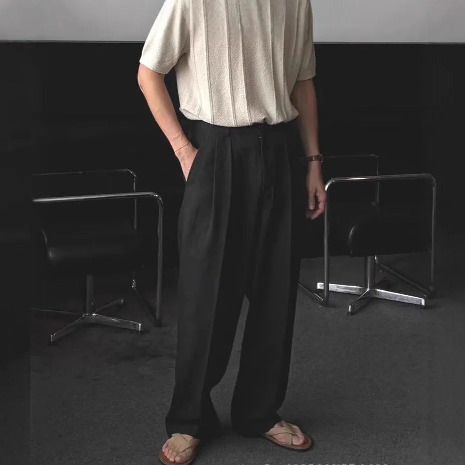 Men's light-weight wide-leg cotton linen trousers in apricot colour, showing loose fit and zip placket.