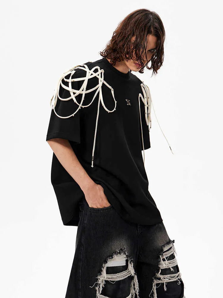Black loose fit short sleeve t-shirt with rivet ribbon detail on padded shoulders.